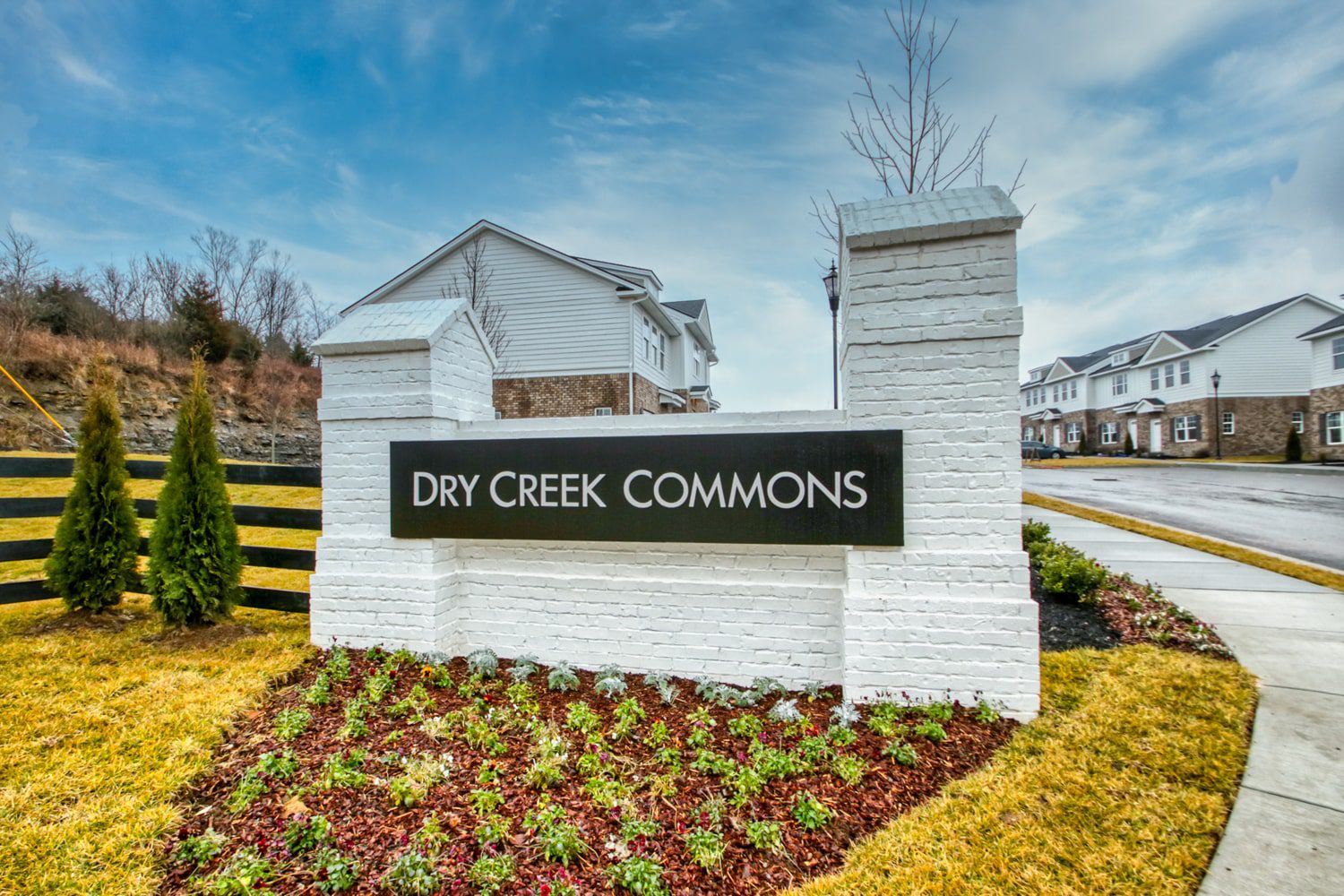 Dry Creek Commons exterior sign on top of a grass covered field